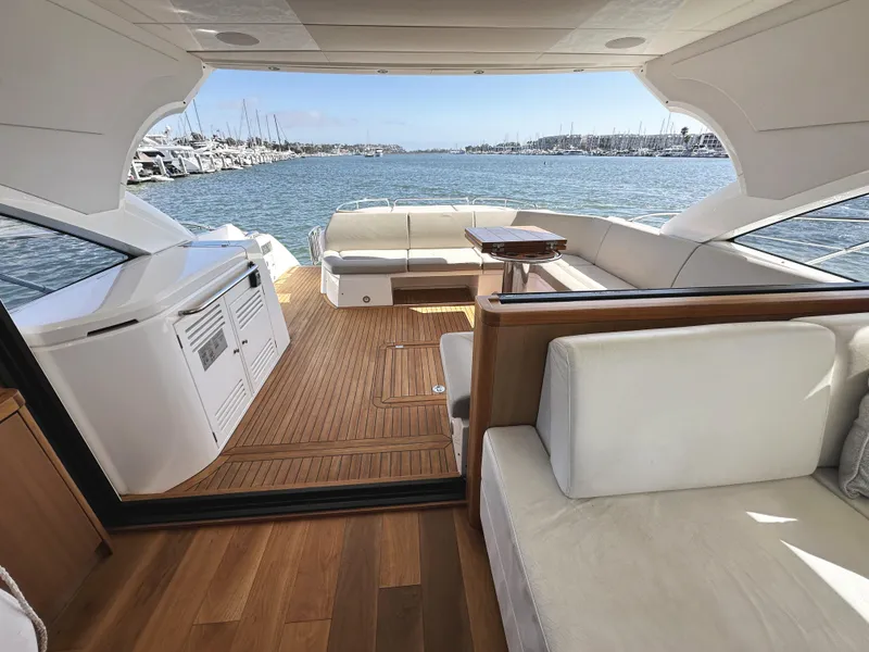 Slide: The Image of Luxurious 2019 Sunseeker Predator 57 yacht interior with elegant seating and scenic marina view. - 21