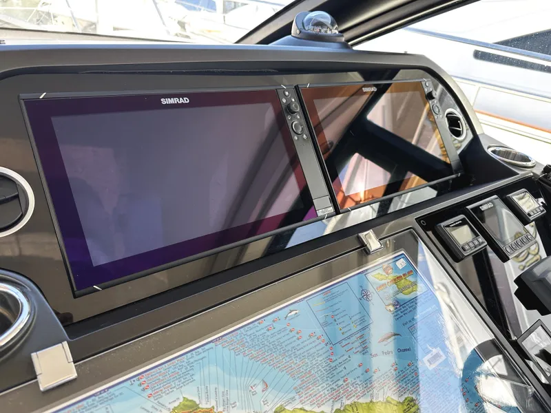 Slide: The Image of Control panel of 2019 Sunseeker Predator 57 yacht with Simrad displays and navigation map. - 28