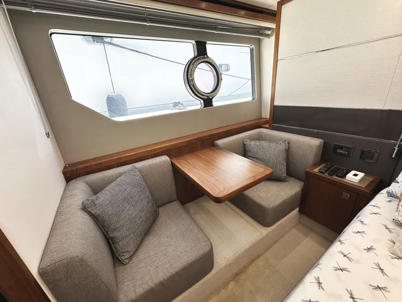 Slide: The Image of Interior of 2019 Sunseeker Predator 57 yacht with cozy seating and wooden table. - 46