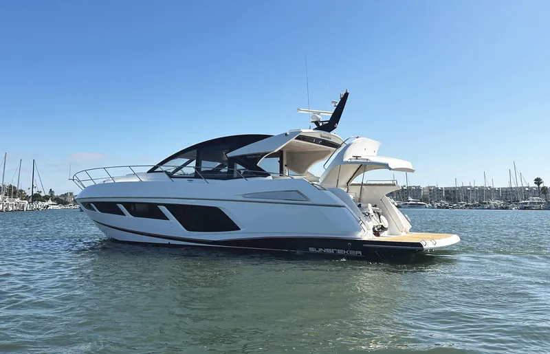 Slide: The Image of 2019 Sunseeker Predator 57 yacht on calm water, clear sky background. - 5