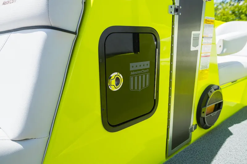 Slide: The Image of 2018 MasterCraft X23 boat interior with vibrant yellow detailing and speaker. - 11
