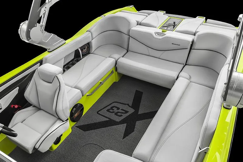Slide: The Image of Manufacturer Provided Image: 2018 MasterCraft X23 boat interior with gray seating and lime green accents. - 12