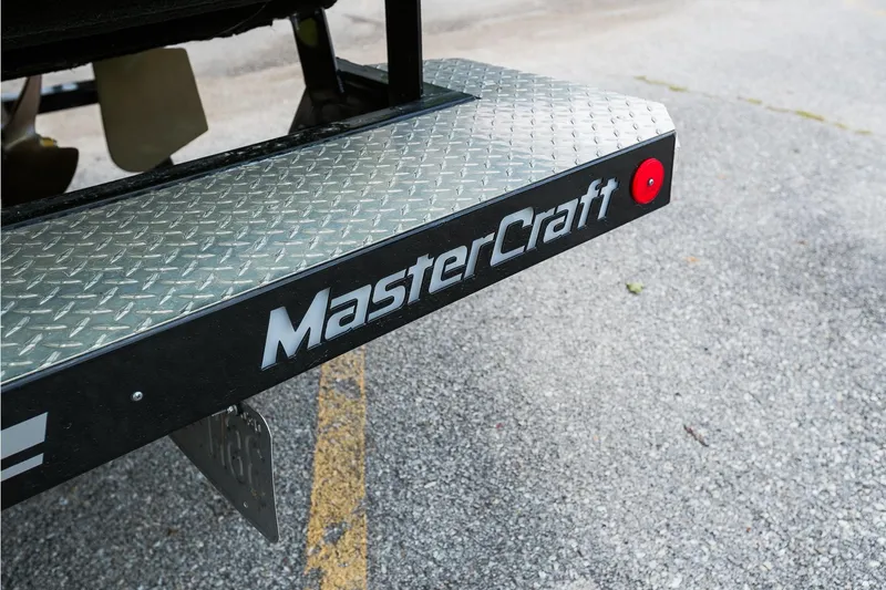 Slide: The Image of 2018 MasterCraft X23 boat trailer with diamond plate surface and logo. - 17