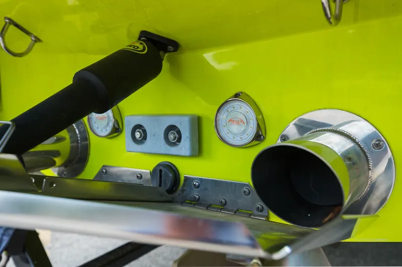 Slide: The Image of Close-up of 2018 MasterCraft X23 boat's rear detailing, featuring exhaust and control elements. - 21