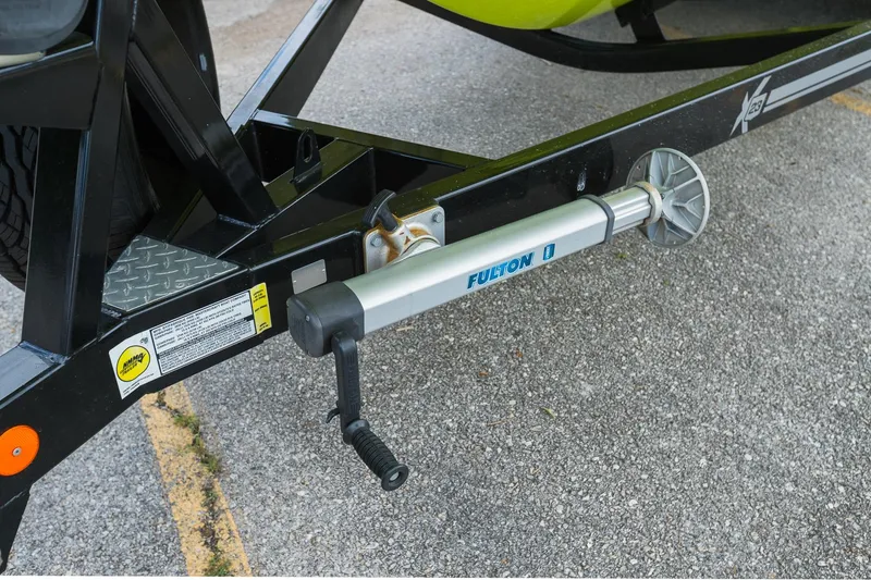 Slide: The Image of Trailer jack on 2018 MasterCraft X23 boat trailer, featuring Fulton branding. - 25
