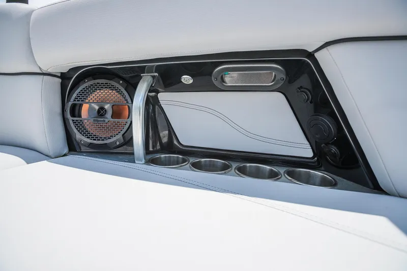 Slide: The Image of 2018 MasterCraft X23 boat interior with speaker and cup holders. - 32