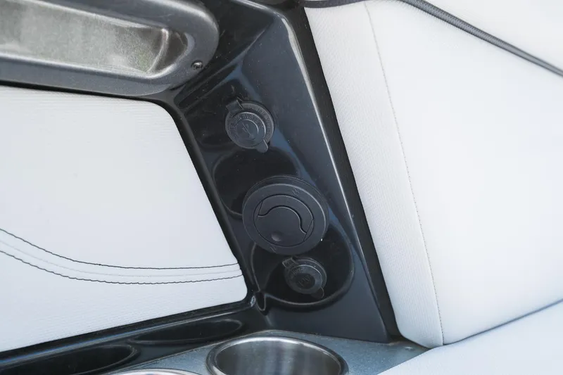 Slide: The Image of 2018 MasterCraft X23 interior detail with cup holder and power outlets. - 33