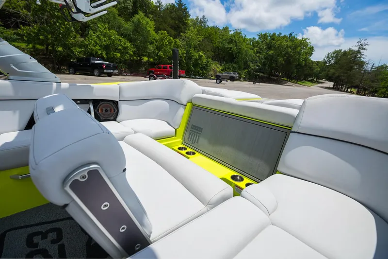 Slide: The Image of 2018 MasterCraft X23 boat interior with white seating and vibrant yellow accents. - 34