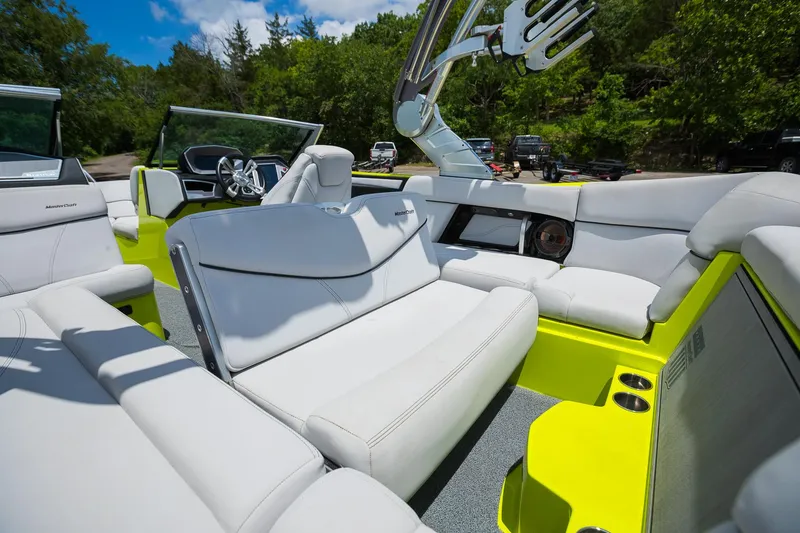 Slide: The Image of 2018 MasterCraft X23 boat interior with white seating and vibrant yellow accents. - 35