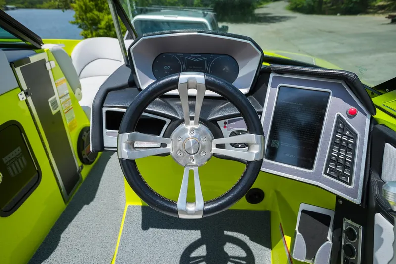 Slide: The Image of 2018 MasterCraft X23 boat dashboard with steering wheel and digital controls, featuring a vibrant interior. - 41