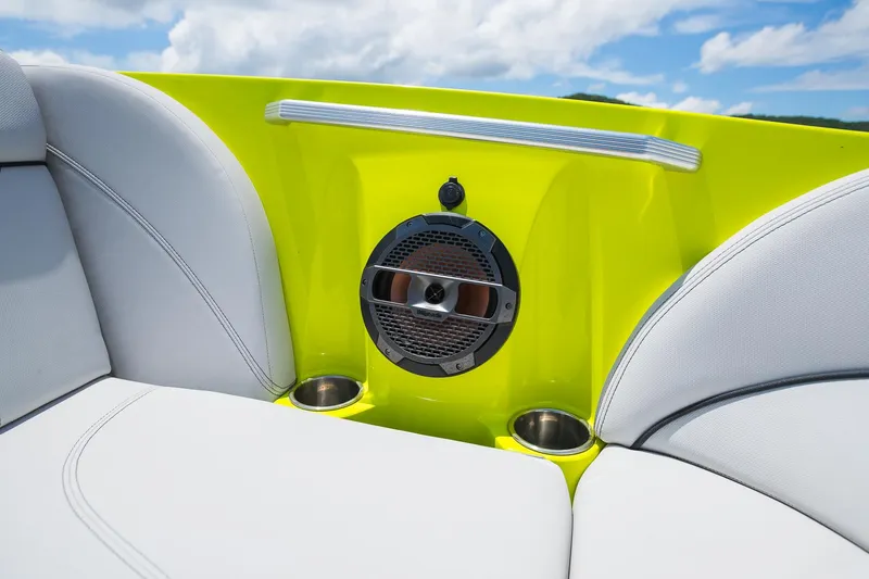 Slide: The Image of 2018 MasterCraft X23 boat interior with speaker, cup holders, and white seating. - 49