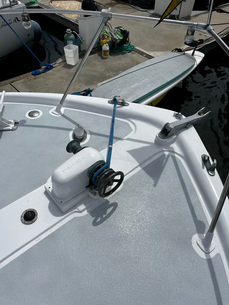 Slide: The Image of Deck of 1965 Hatteras 41 Twin Cabin with winch and docked paddleboard. - 16