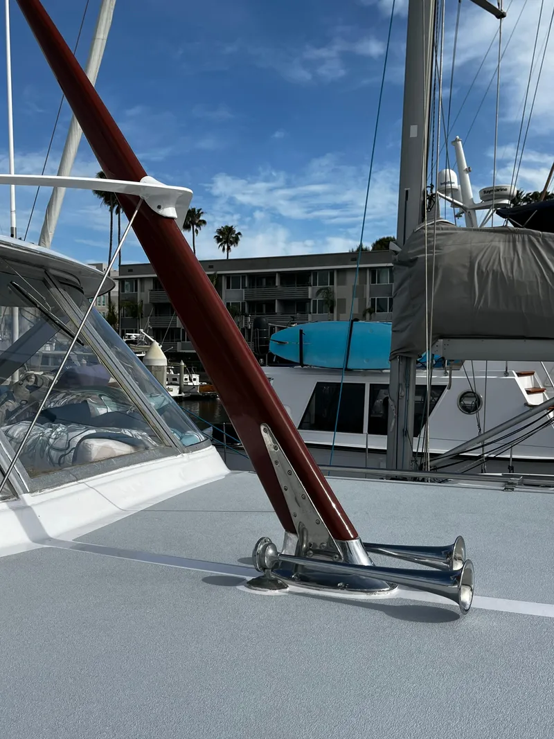 Slide: The Image of 1965 Hatteras 41 Twin Cabin yacht deck with rigging, marina background, clear sky. - 17