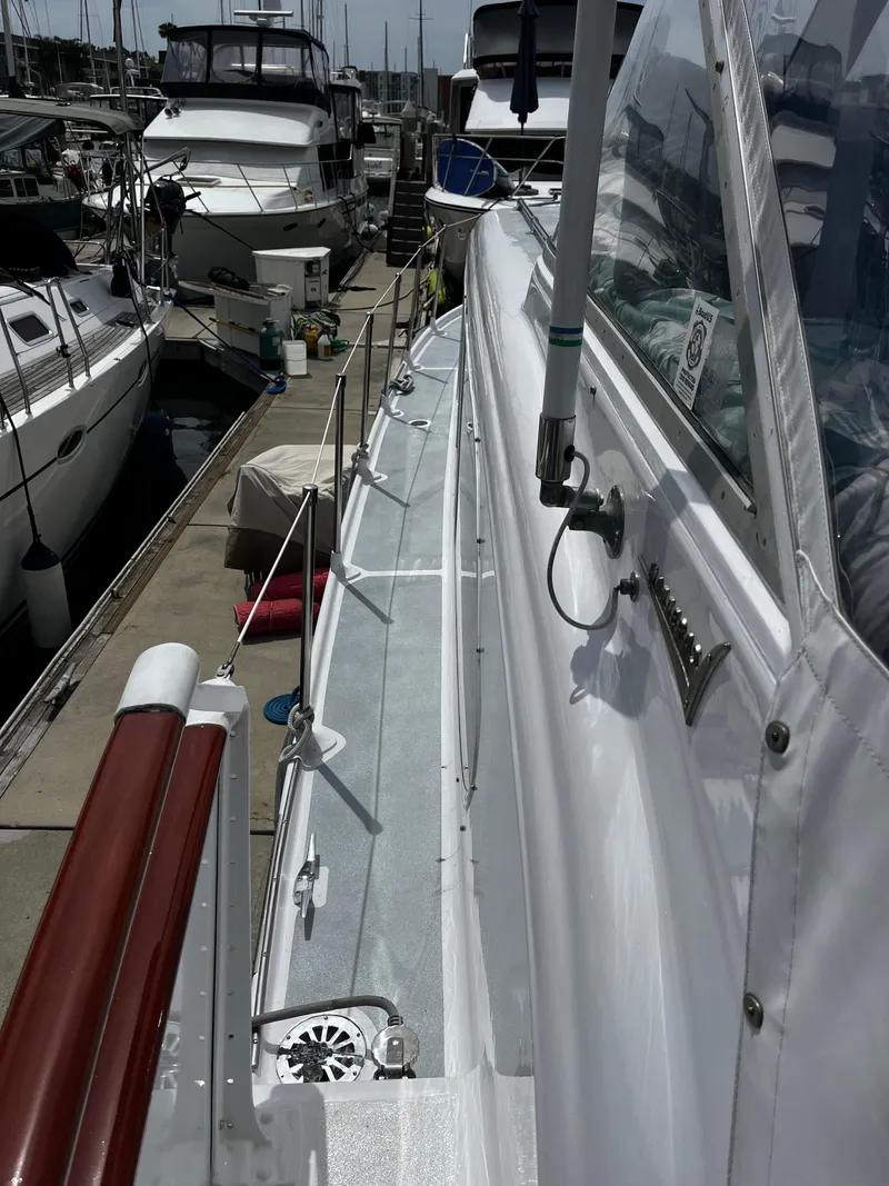 Slide: The Image of 1965 Hatteras 41 Twin Cabin yacht docked at marina, side view. - 19