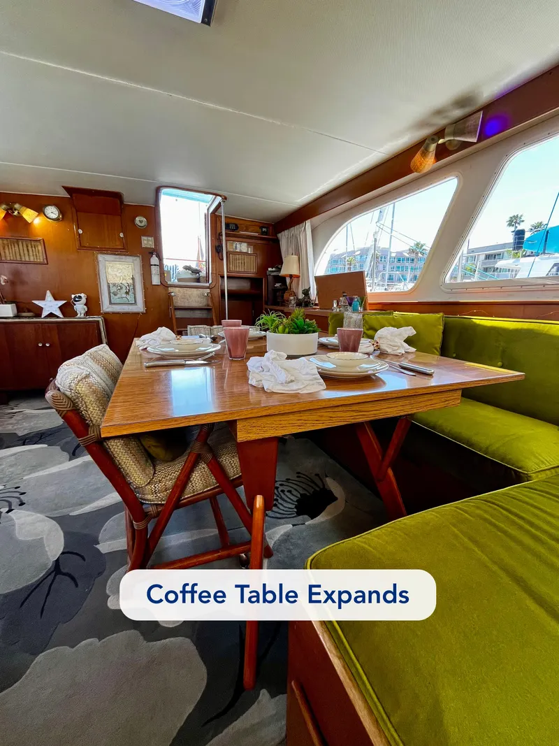 Slide: The Image of Interior of 1965 Hatteras 41 Twin Cabin with expandable coffee table and green seating. - 21