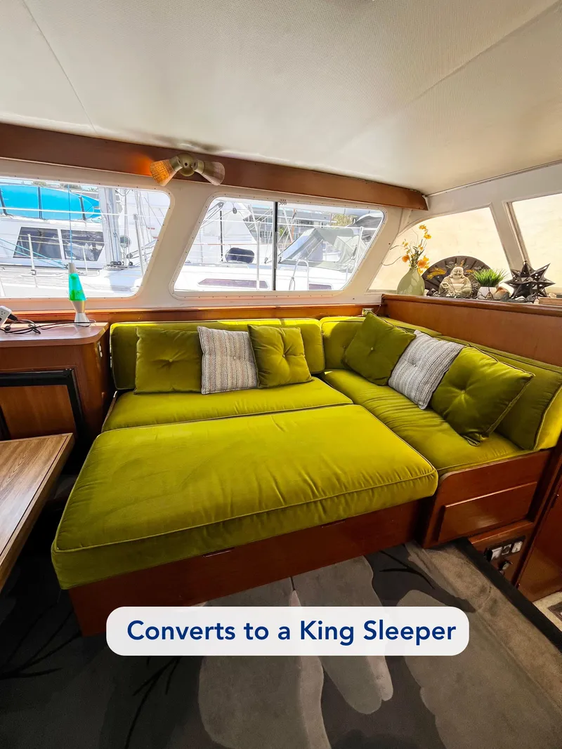 Slide: The Image of 1965 Hatteras 41 Twin Cabin interior with green sofa converting to king sleeper. - 22