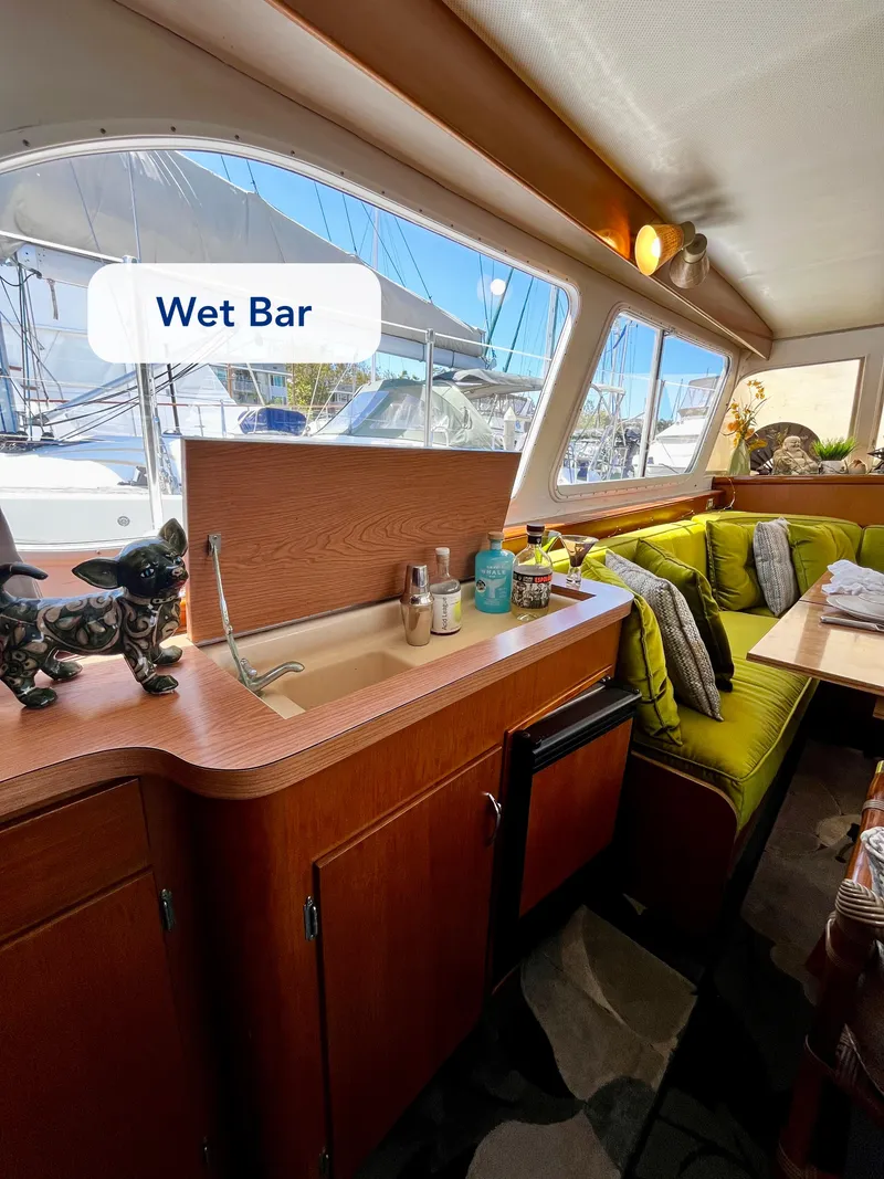 Slide: The Image of 1965 Hatteras 41 Twin Cabin interior with wet bar and cozy seating area. - 24
