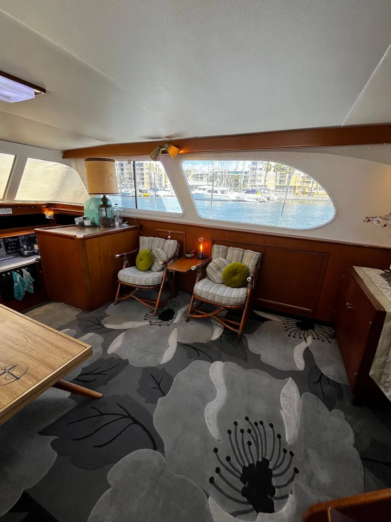 Slide: The Image of Interior of 1965 Hatteras 41 Twin Cabin with floral carpet and cozy seating area. - 25