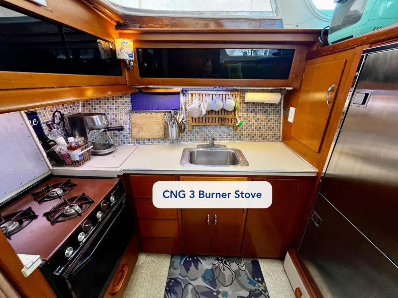 Slide: The Image of 1965 Hatteras 41 Twin Cabin kitchen with CNG 3 burner stove and sink. - 28