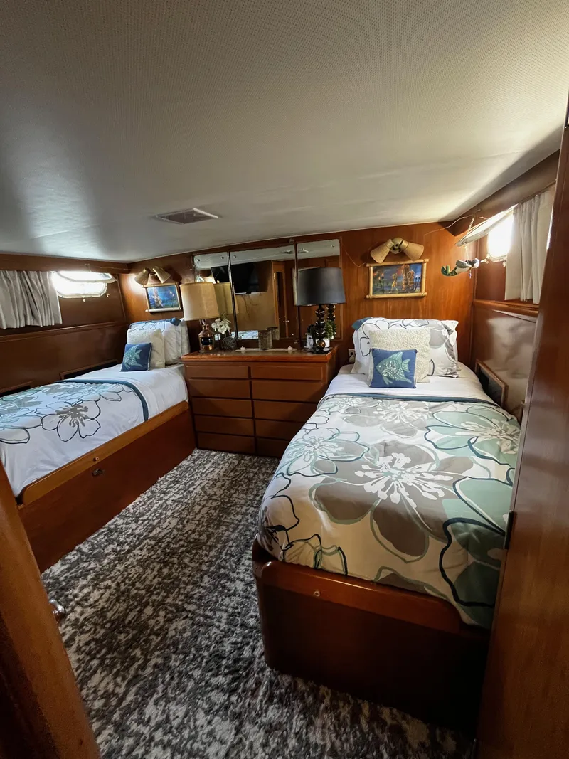 Slide: The Image of 1965 Hatteras 41 Twin Cabin interior with twin beds, floral bedding, and wooden furnishings. - 30
