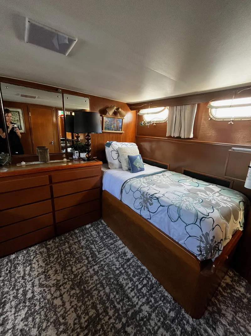 Slide: The Image of 1965 Hatteras 41 Twin Cabin interior with bed, dresser, and nautical decor. - 32