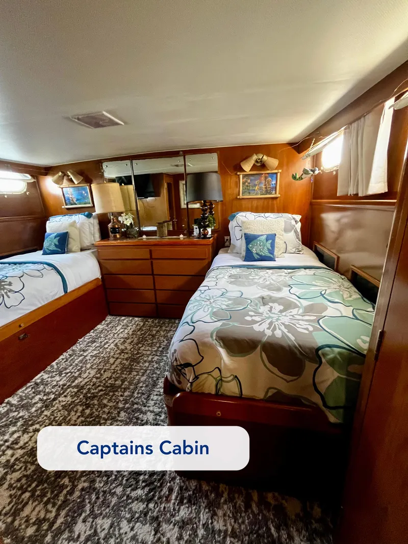Slide: The Image of 1965 Hatteras 41 Twin Cabin interior with twin beds and wooden decor. - 33