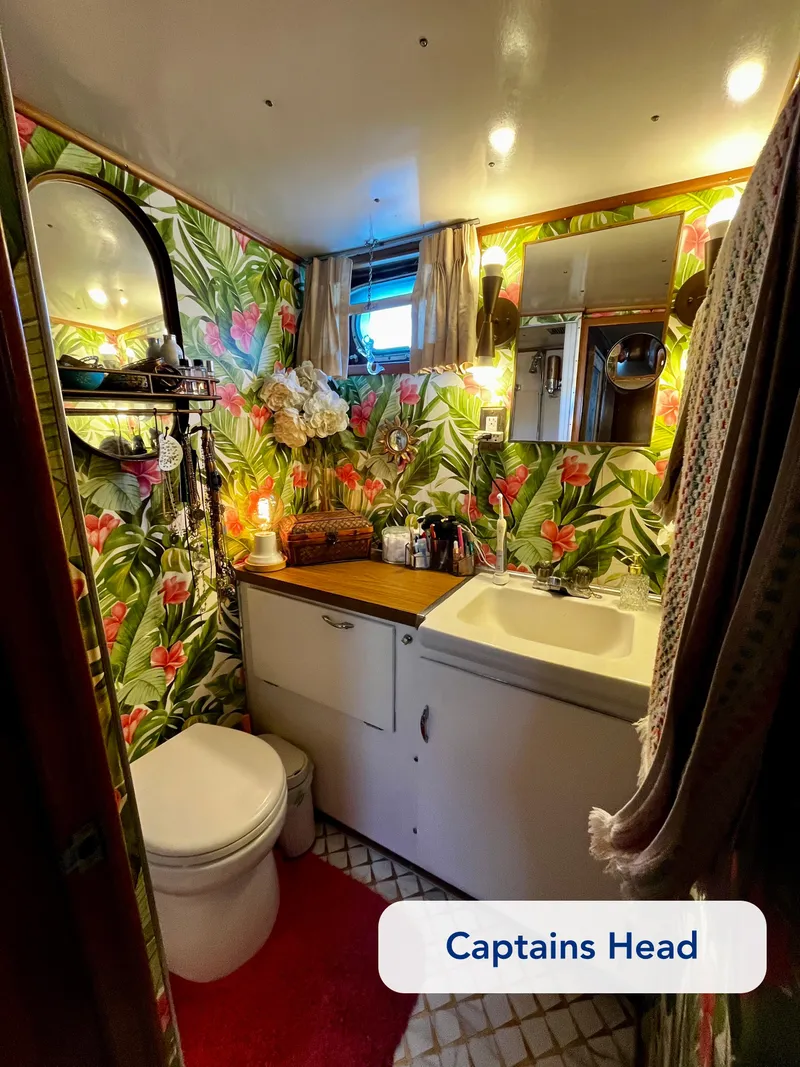 Slide: The Image of Vintage 1965 Hatteras 41 Twin Cabin bathroom with tropical wallpaper and cozy decor. - 34