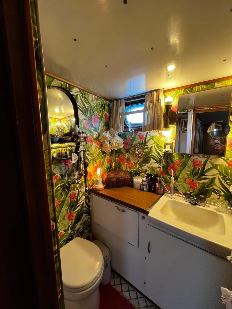 Slide: The Image of Vintage Hatteras 41 Twin Cabin bathroom with tropical wallpaper and cozy decor, 1965 model. - 36
