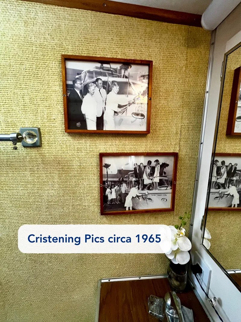 Slide: The Image of Framed black-and-white christening photos on a wall, Hatteras 41 Twin Cabin, 1965. - 40