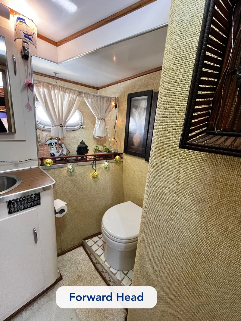 Slide: The Image of 1965 Hatteras 41 Twin Cabin forward head with nautical decor and compact design. - 41