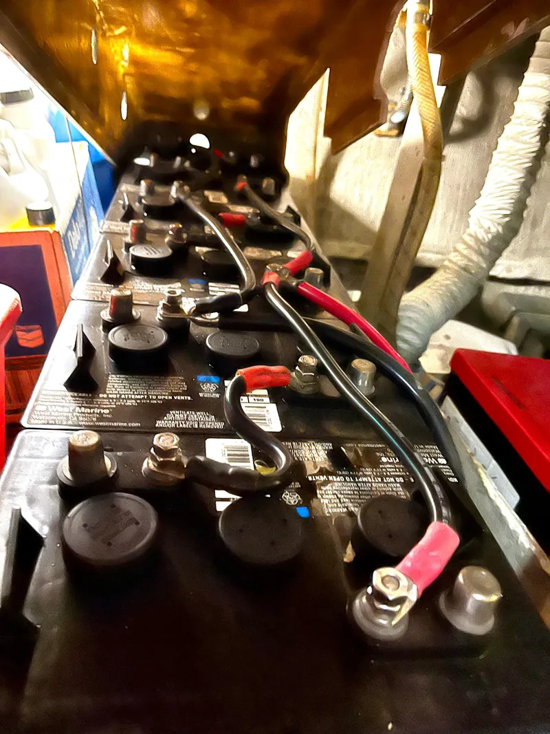 Slide: The Image of Battery setup in 1965 Hatteras 41 Twin Cabin engine room, showing cables and connections. - 42