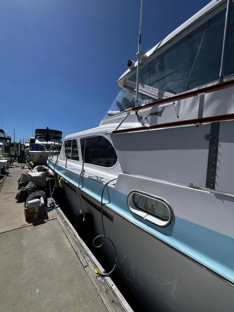 Slide: The Image of 1965 Hatteras 41 Twin Cabin yacht docked under clear blue sky. - 5