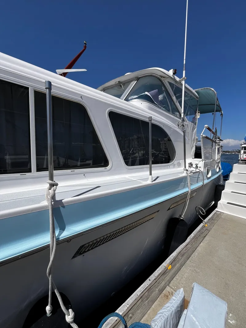 Slide: The Image of 1965 Hatteras 41 Twin Cabin yacht docked under clear blue sky. - 6