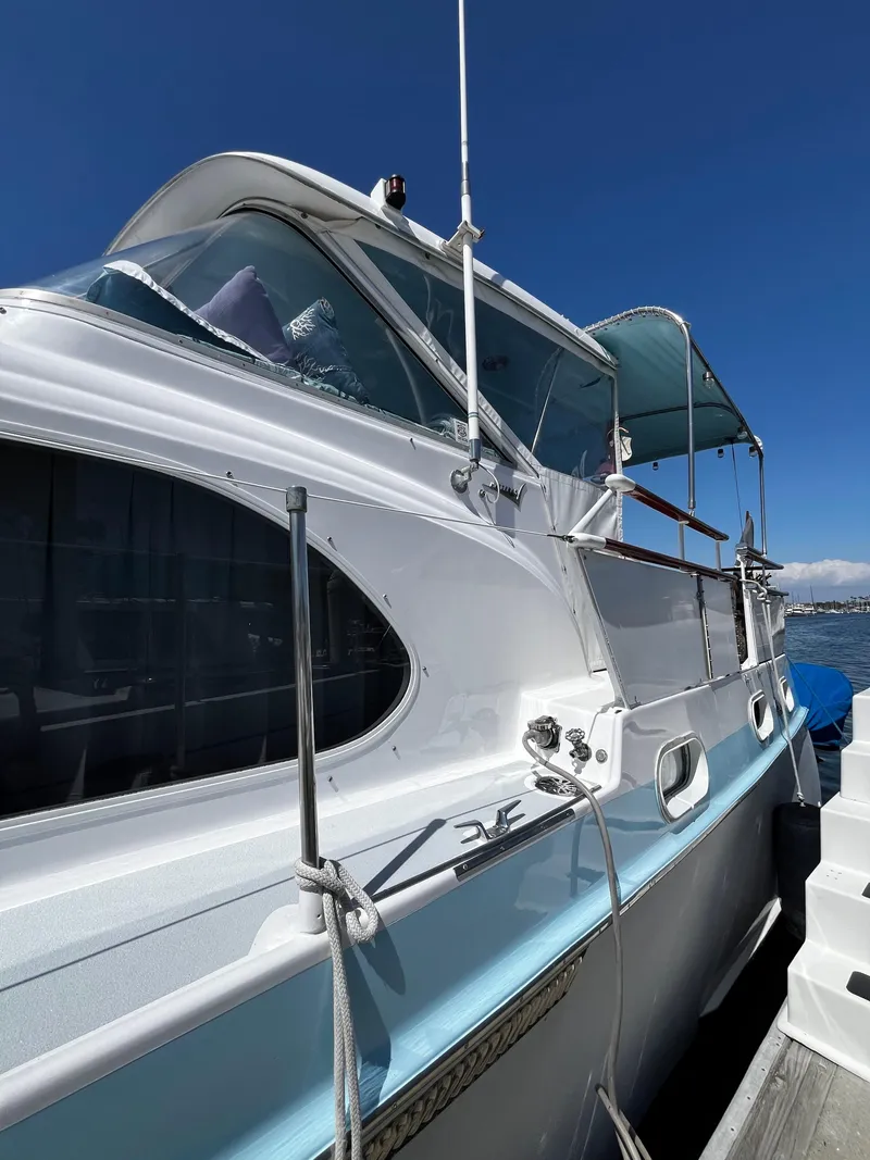 Slide: The Image of 1965 Hatteras 41 Twin Cabin yacht docked under clear blue sky. - 7