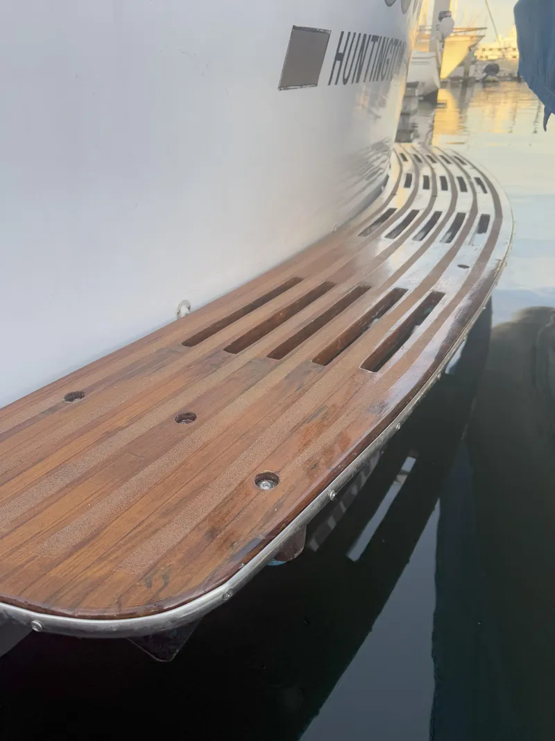 Slide: The Image of Teak swim platform on 1965 Hatteras 41 Twin Cabin yacht, docked in marina. - 9