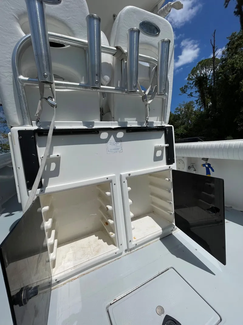 Slide: The Image of 1998 Regulator 26 Classic boat with open storage compartments and rod holders. - 13