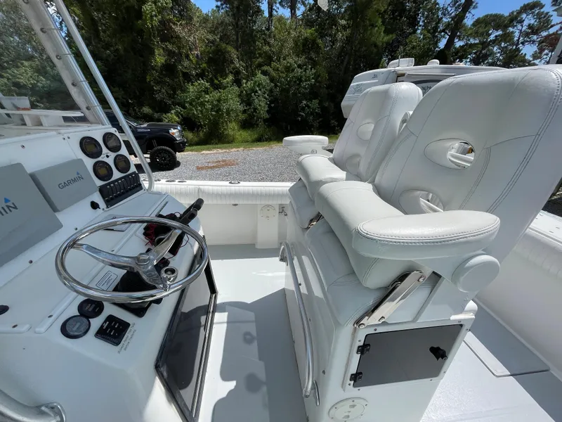 Slide: The Image of 1998 Regulator 26 Classic boat cockpit with white seats and steering wheel. - 14