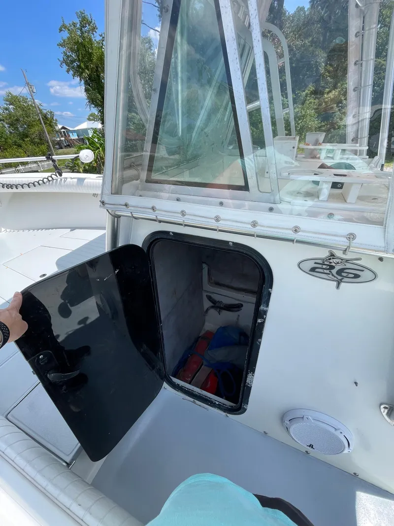 Slide: The Image of 1998 Regulator 26 Classic boat with open storage compartment. - 18