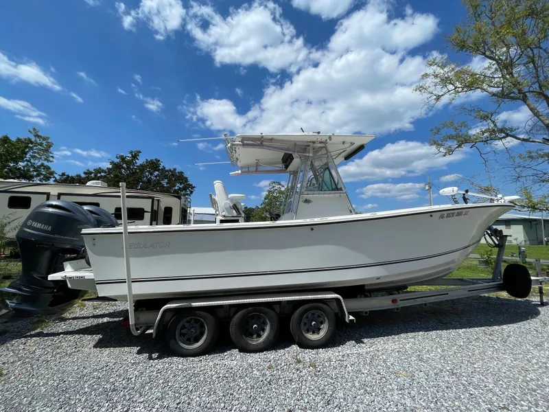 Slide: The Image of 1998 Regulator 26 Classic boat on a trailer with Yamaha outboard motors. - 2