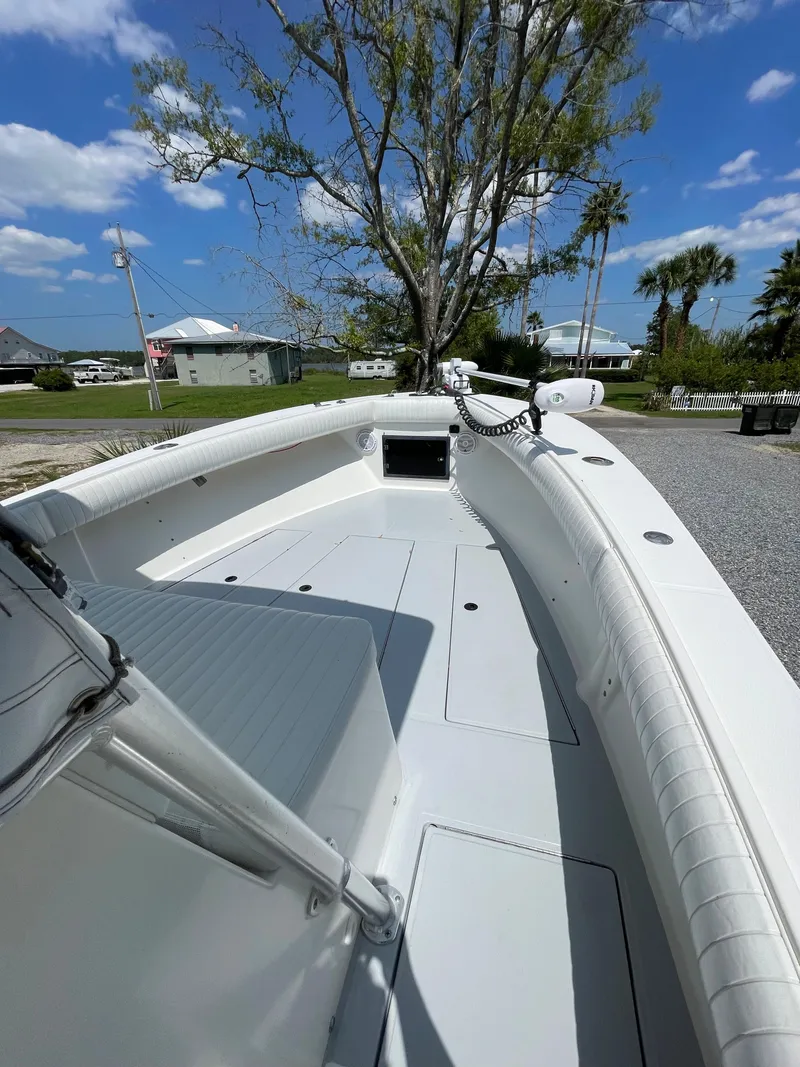 Slide: The Image of 1998 Regulator 26 Classic boat with spacious deck and seating, docked under clear skies. - 20
