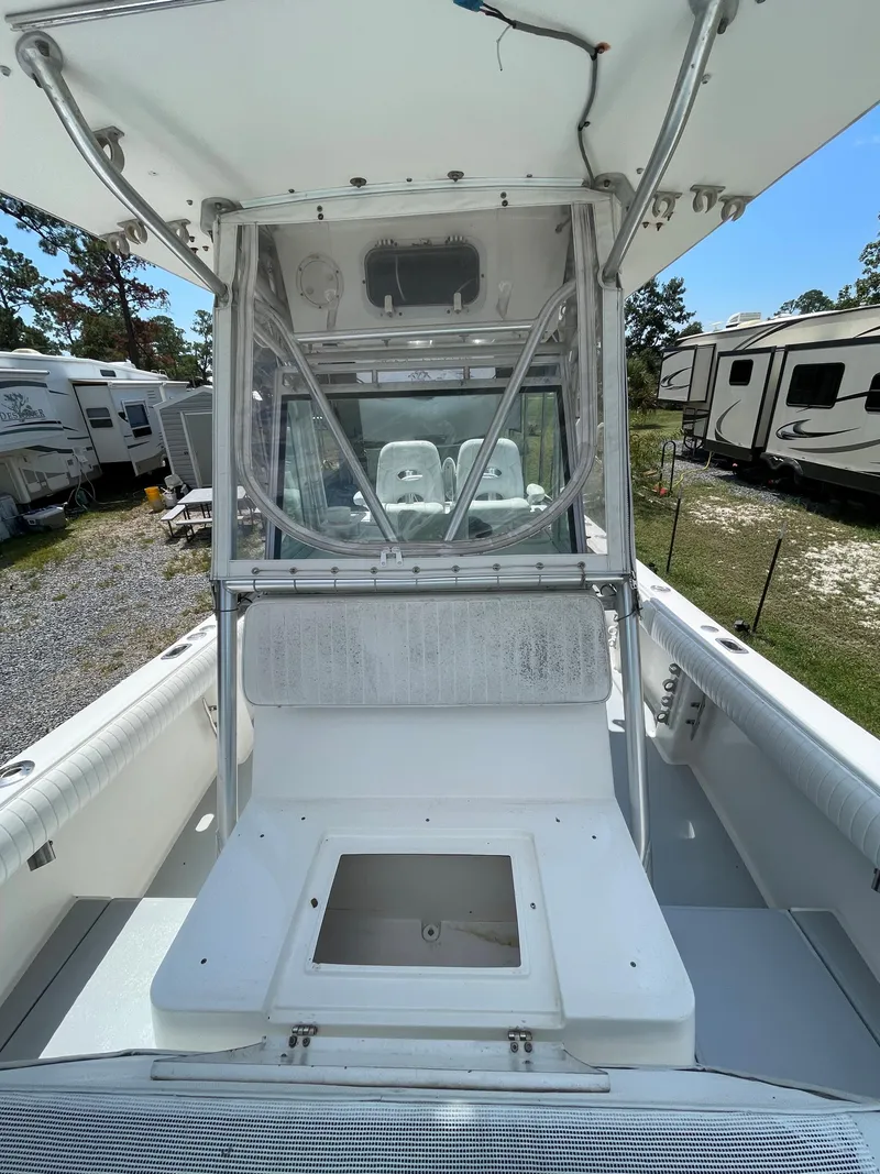 Slide: The Image of 1998 Regulator 26 Classic boat with center console and seating area. - 24