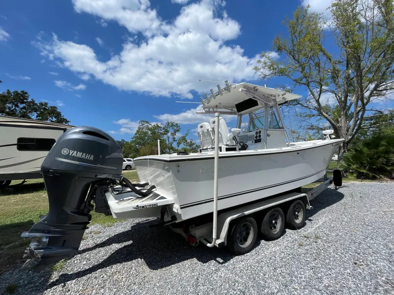 Slide: The Image of 1998 Regulator 26 Classic boat on a trailer with Yamaha outboard motor. - 3
