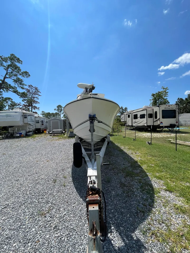 Slide: The Image of 1998 Regulator 26 Classic boat on trailer in RV park. - 5