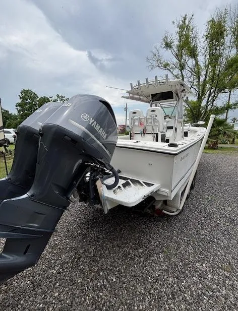 Slide: The Image of 1998 Regulator 26 Classic boat with Yamaha outboard motor on gravel surface. - 7