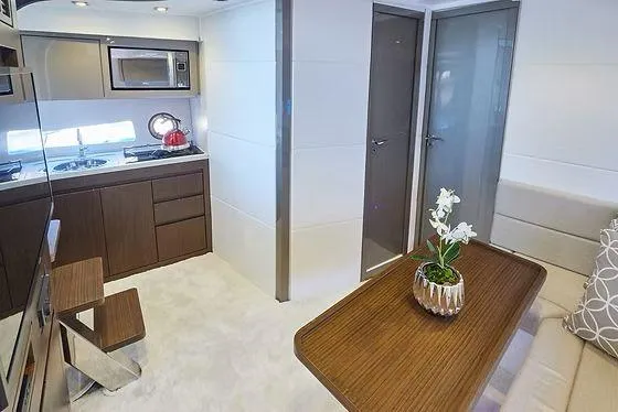 Slide: The Image of Modern yacht interior with kitchenette, dining area, and elegant decor in Schaefer 400, 2026 model. - 12