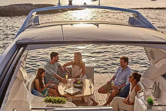 Slide: The Image of People enjoying a sunset gathering on a 2026 Schaefer 400 yacht. - 16