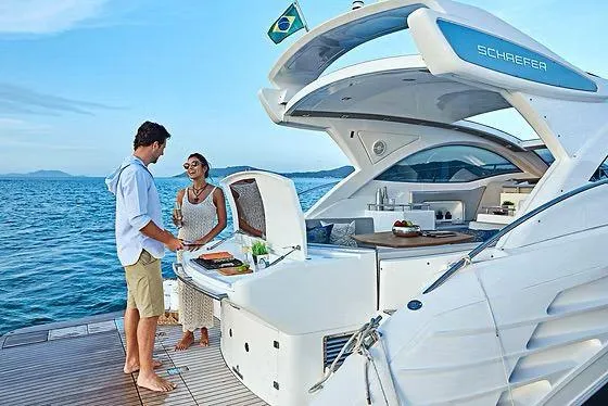 Slide: The Image of Couple enjoying leisure time on a 2026 Schaefer 400 yacht, ocean backdrop. - 18