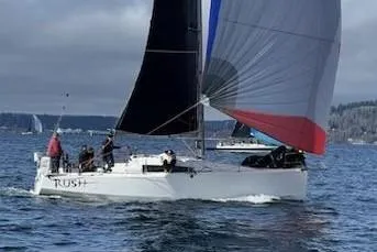 The Image of 2018 Jeanneau Sun Fast 3600 sailboat racing on open water with colorful spinnaker. - 0