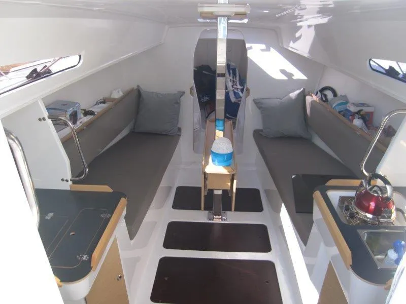 Slide: The Image of Interior of 2018 Jeanneau Sun Fast 3600 sailboat with seating and compact kitchen area. - 10