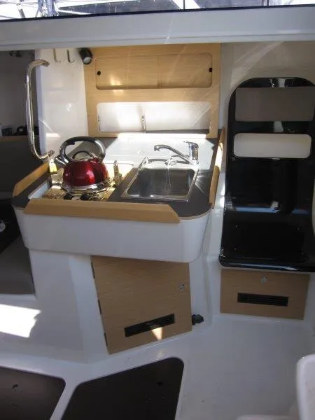 Slide: The Image of 2018 Jeanneau Sun Fast 3600 yacht interior with compact kitchen and red kettle. - 11